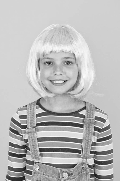 New smile new look. Little girl smile in short pink hair wig. Happy child smile yellow background. Small kid with white healthy smile. Art of dentistry. Dental care you can trust - Foto, Imagen