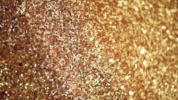 Sparkle glittering background. Holiday abstract texture. Christmas card with gold bokeh, defocused lights. - Footage, Video