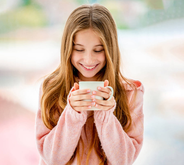Sweet girl drinking from cup - 写真・画像