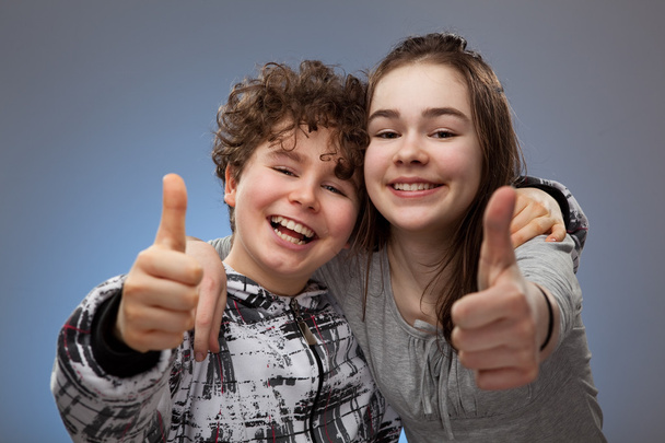 Boy and girl showing thumbs up sign - Fotó, kép