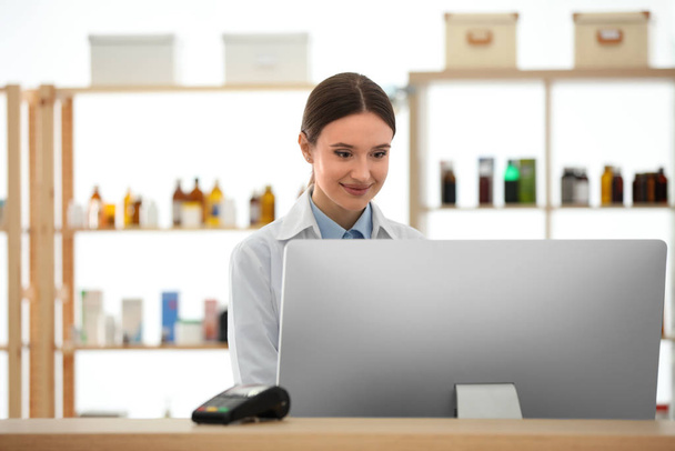 Professional pharmacist working with computer in drugstore - Fotografie, Obrázek