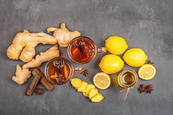 Ginger tea with lemon and honey on gray concrete background. Flat lay, top view, mock up, template, copy space, overhead - Foto, imagen