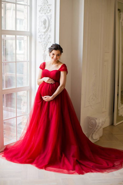 Pregnant woman at red dress - Photo, Image