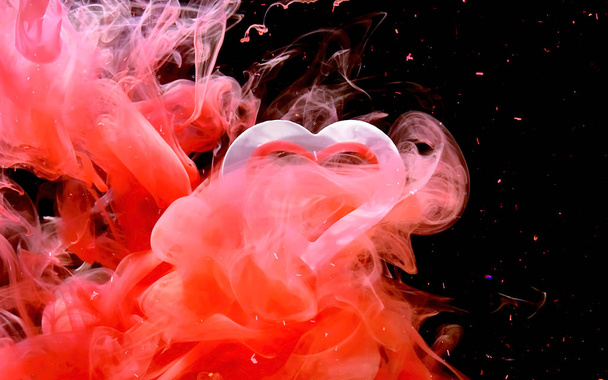 Concept for Valentine's Day February 14th. Red ink in water on a - 写真・画像