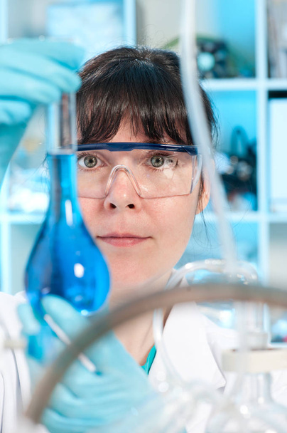 Technician with a measuring glass - Photo, Image