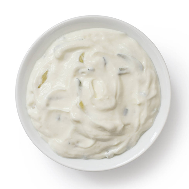 Tzatziki in white ceramic bowl isolated on white from above. - Fotoğraf, Görsel