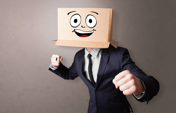 Young boy with happy cardboard box face - Zdjęcie, obraz