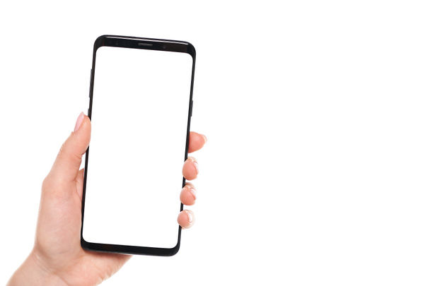 Beyaz arkaplanda modern çerçevesiz tasarımı olan siyah akıllı telefonu elinde tutan kadın. - Fotoğraf, Görsel