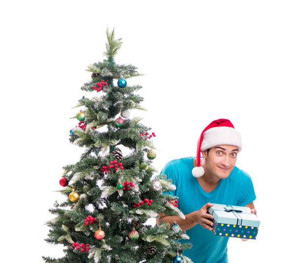 Young man decorating christmas tree isolated on white - 写真・画像