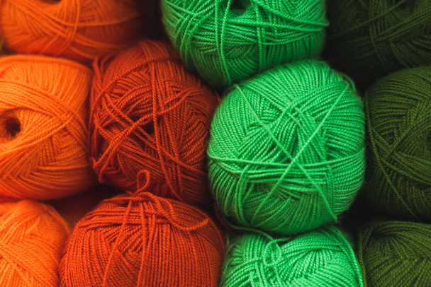 Colored skeins of wool on a store shelf. Woolen skeins for knitting all the colors of the rainbow, green, brown, red and orange - Photo, image