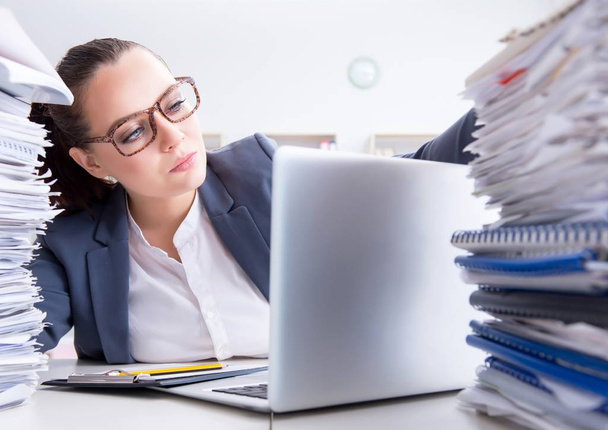 Tired businesswoman with paperwork workload - Foto, Imagem
