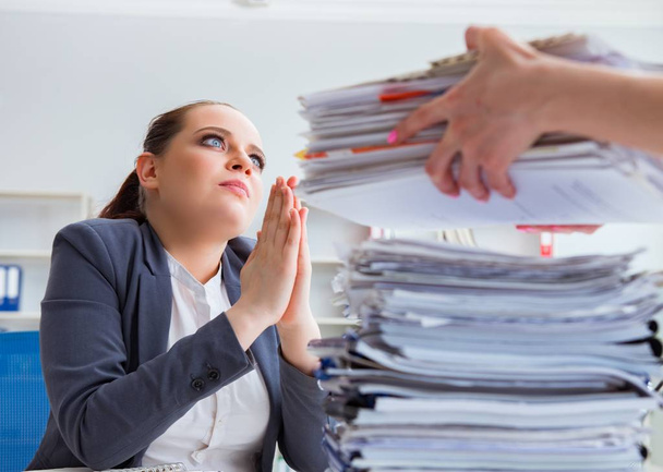 Tired businesswoman with paperwork workload - Photo, Image