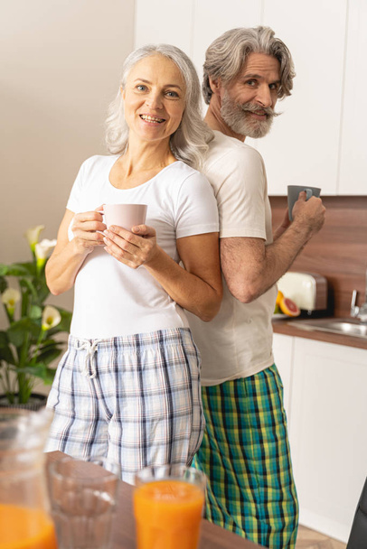 Two people holding coffee mugs in their hands - Photo, image