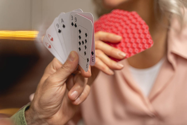 Hands of two mature players holding cards - Foto, immagini