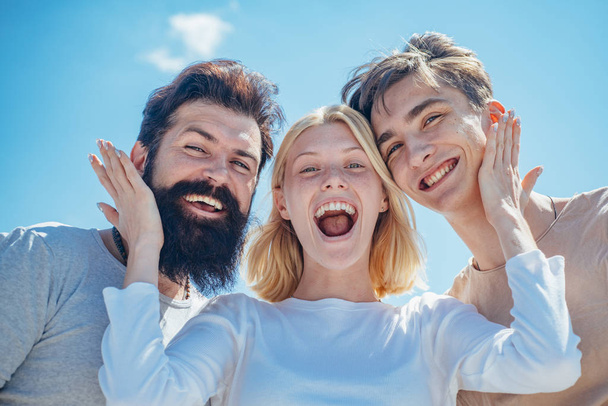 Team of best friends spend their carefree time communicating. Hipster style. Stylish men. Summer. Group of cheerful young people men and woman isolated on sky background. - Photo, Image