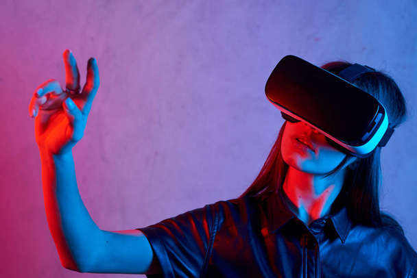 Menina usando capacete realidade virtual enquanto vestindo uma jaqueta
 - Foto, Imagem