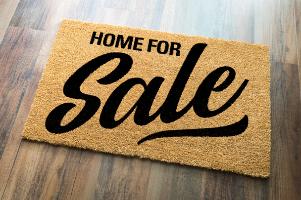 Home For Sale Welcome Mat On A Wood Floor Background - Photo, Image