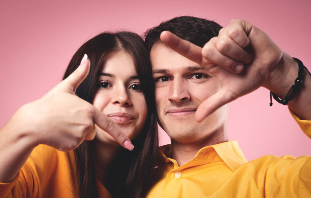 Cheerful emotional young couple posing together on camera - Fotoğraf, Görsel