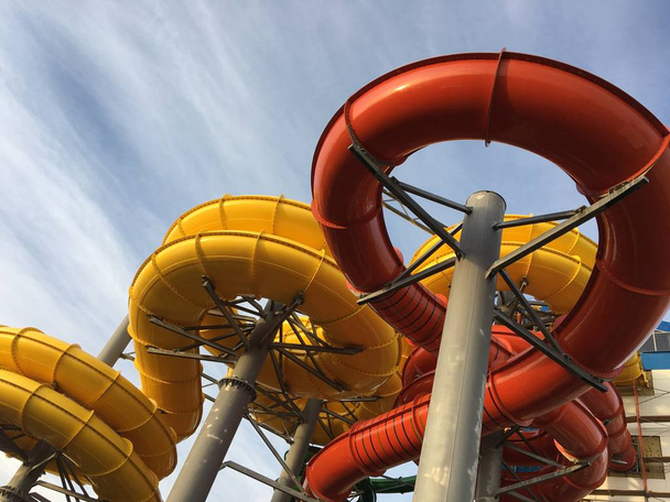 pipes of the water park on the street in red and yellow - Photo, Image
