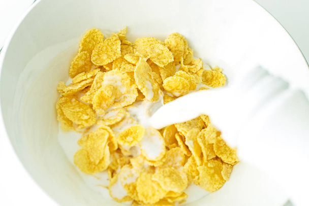 cereal with milk in a white plate for breakfast, space for text, isolate - Photo, Image