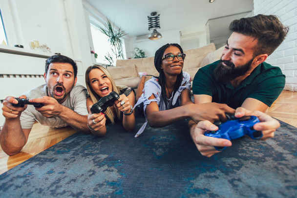 Group of friends playing video games at home. - Photo, Image