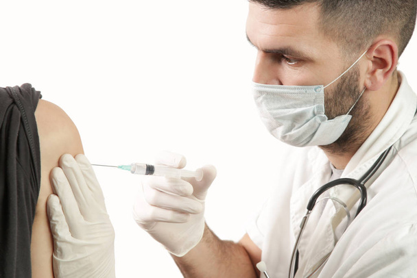 Doctor giving patient vaccine, flu or influenza shot - Fotografie, Obrázek