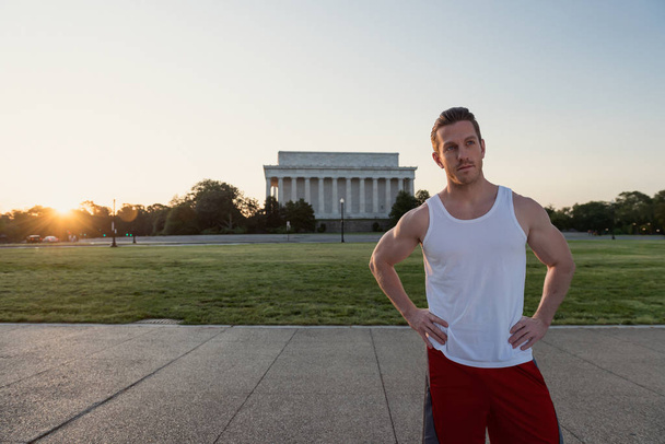 Handsome Caucasian man portrait while resting during a workout outdoors at the National Mall in Washington DC - Fotó, kép
