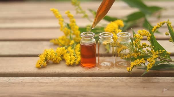 goldenrod essential oil in  beautiful bottle on table - Footage, Video