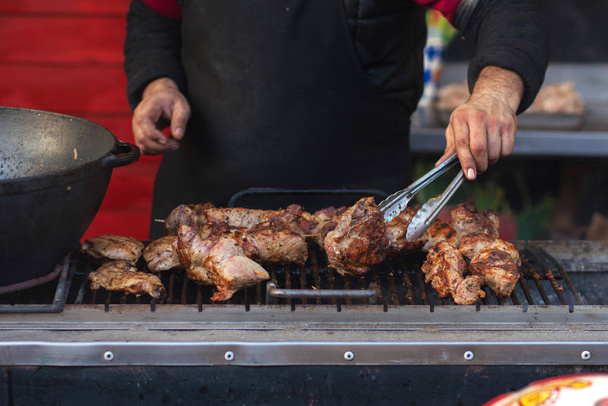 Street food on the grill. Meat on skewers, barbecue. - 写真・画像