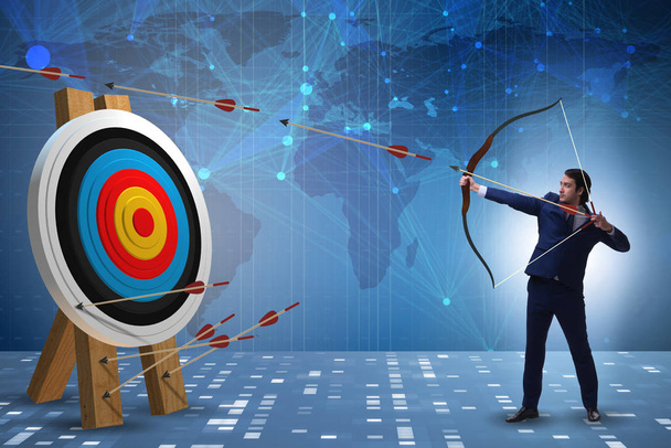 Businessman aiming arrow with bow - Photo, Image