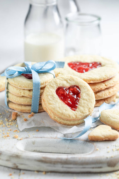 Gorgeous valentine cookies with red strawberries jam - 写真・画像