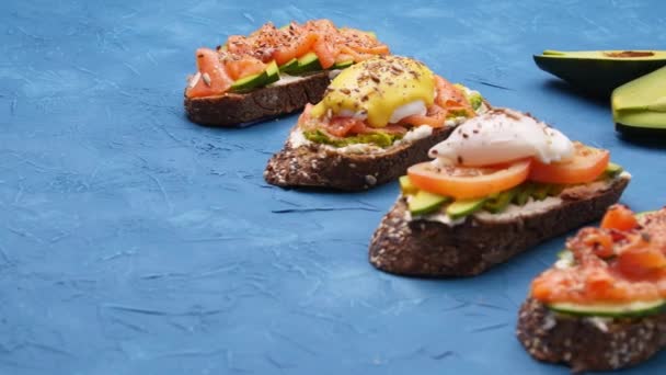 Breakfast and Snack Concept. Bruschettas on a blue table - Footage, Video