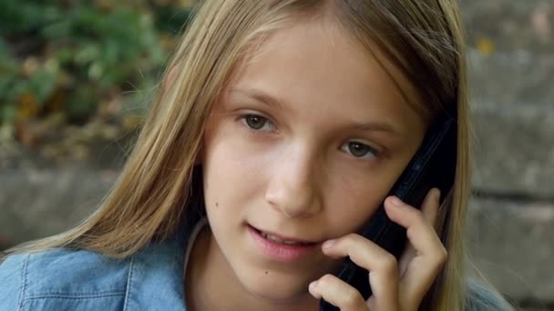 Child Talking on Smartphone, Kid Using Smart Phone, Girl Playing Outdoor in Park - Felvétel, videó