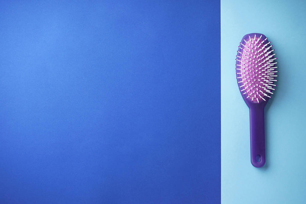 Purple plastic hair brush with place for text. Flat lay. - Fotoğraf, Görsel