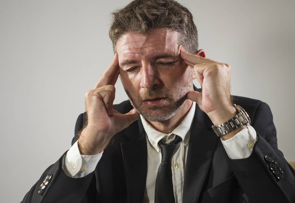 exhausted financial executive man in stress - corporate business lifestyle portrait of stressed and tired businessman suffering headache working frustrated having problem - Photo, image