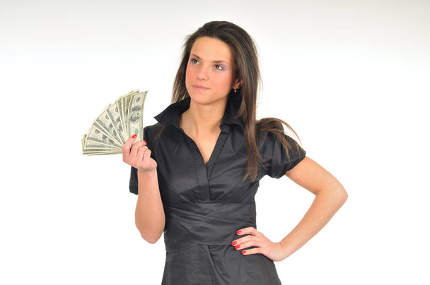 Woman holds dollar bills in her hands - Foto, imagen