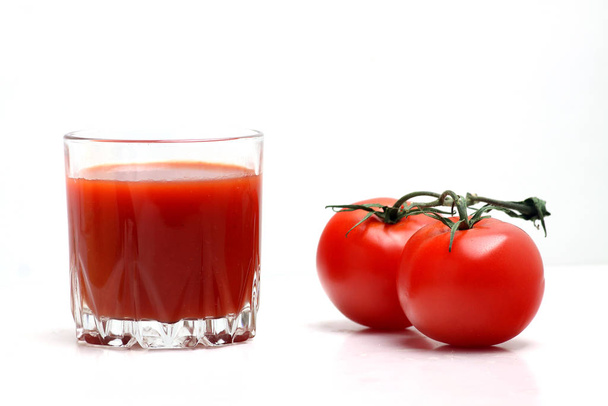 a glass of tomato juice and tomatoes isolated on white backgrond. Horizontal image - Photo, image
