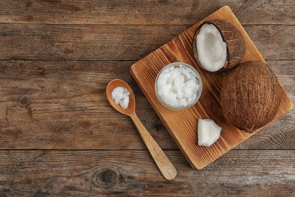 Flat lay composition with coconut oil on wooden table. Cooking i - Photo, image