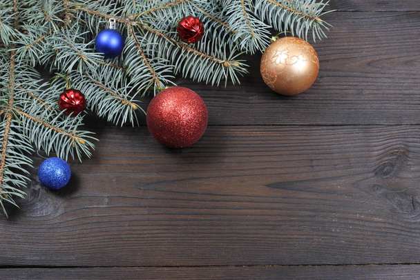New Year's background. New Year's toys on Christmas tree, wooden background. View from above. - Фото, изображение