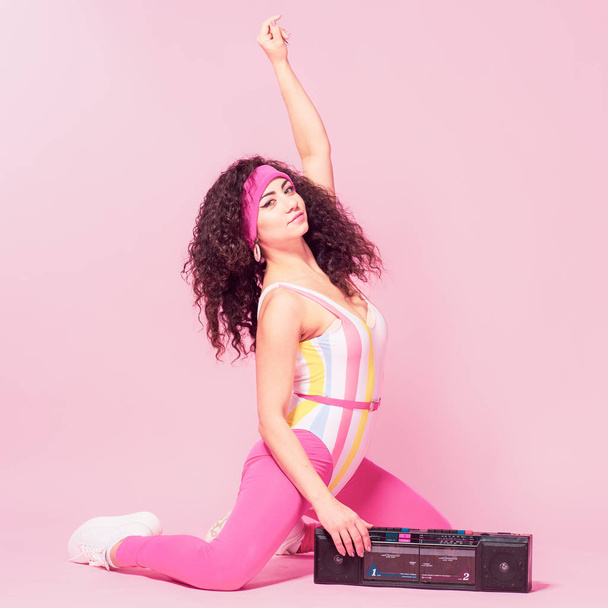 Color background with sport girl, 80s, aerobic. Toned photo - Fotó, kép