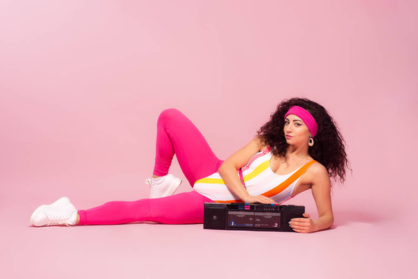 Color background with sport girl, 80s, aerobic. Toned photo - Photo, Image