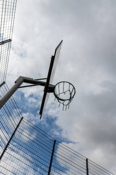 Basketball action with a flying ball from the training and practice to throw and hit the basketball into the basketball basket for success and victory in a tournament with a successful basketball team - 写真・画像