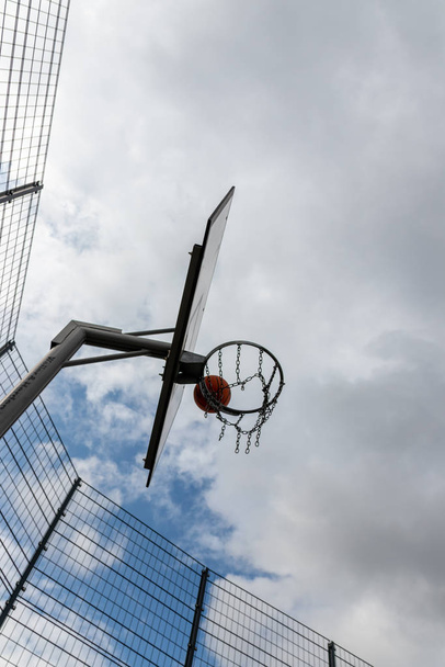 Basketbalová akce s létající míč z tréninku a praxe házet a trefit basketbal do basketbalového koše pro úspěch a vítězství v turnaji s úspěšným basketbalovým týmem - Fotografie, Obrázek