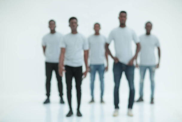 blurry image of a group of young men in white t-shirts - Фото, изображение