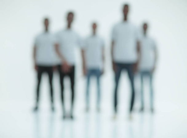 blurry image of a group of young men in white t-shirts - Фото, зображення