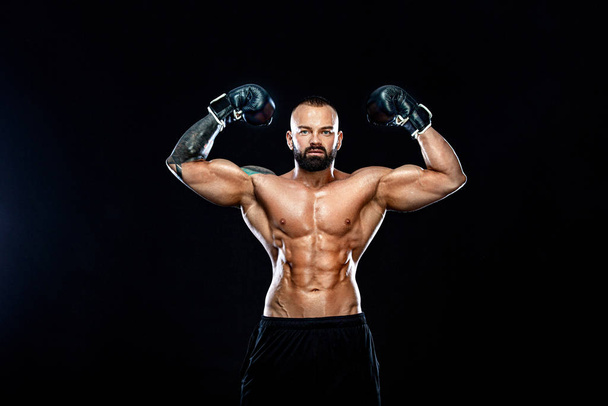 Fitness and boxing concept. Boxer, man fighting or posing in gloves on black background. Individual sports recreation. - Foto, Imagem