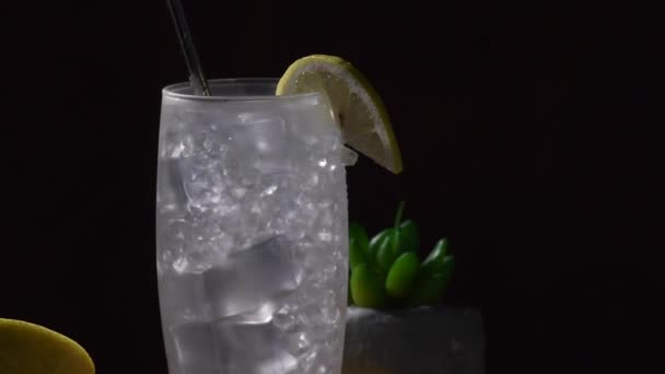 Tom Collins cocktail in a black background, eco-friendly metal straw, rotate video - Footage, Video