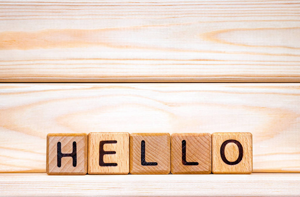 Hello word concept. The word Hello on wooden cubes. Hello background. Hello invitation. Hello background. Greeting hello. Wooden background. Meeting, salutation, salute, welcome concept - Photo, Image