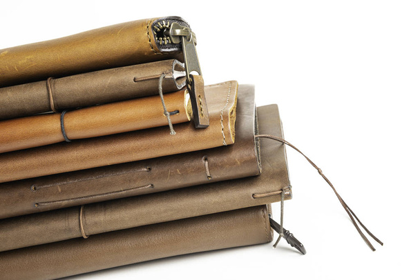 A Stack of Leather-Bound Journals, Notebooks, Wallets & Cases
 - Фото, изображение