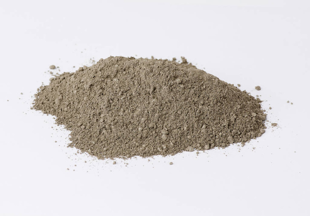 pile of gray dry Crimean fine clay on a white background - Photo, Image